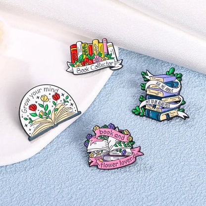 Four colorful enamel pins with book-themed designs and positive messages like Book Collector and Grow your mind—the perfect book lover badges for any romance reader. Features include books with flowers, banners, and open books.