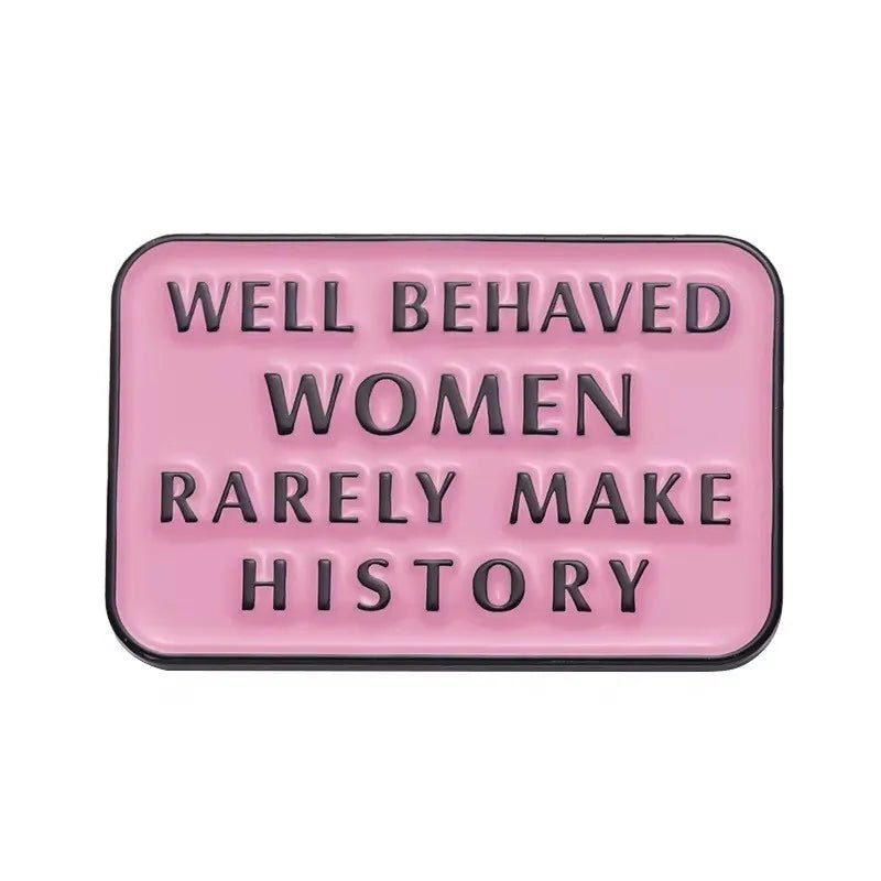 rectangular pink enamel pin features black raised letters stating WELL BEHAVED WOMEN RARELY MAKE HISTORY, making this badge a standout statement piece for any collection.