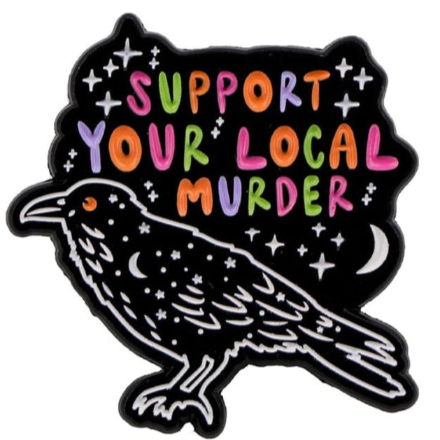 A stylized black raven with star-like dots appears under colorful “Support Your Local Murder” text, surrounded by stars, a crescent moon, and accented with a unique coffin badge 