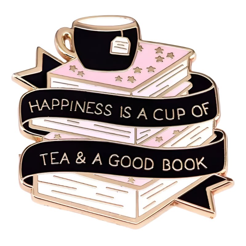 The My Cutesy Era enamel pin features a teacup on pink books with gold stars and a black ribbon that reads, Happiness is a cup of tea & a good book—a perfect gift for tea and book lovers.