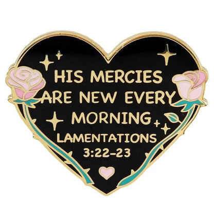 My Cutesy Era heart-shaped enamel pin features pink roses, gold accents, and the text: His Mercies Are New Every Morning. Lamentations 3:22-23 on a black background.