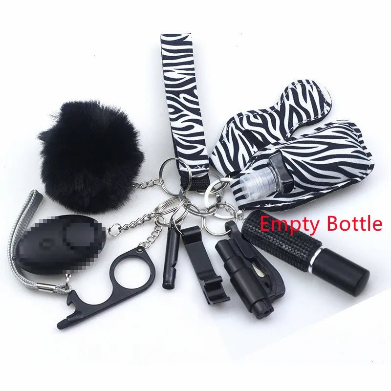 The Kiss Me Later zebra-print keychain set features personal safety accessories—an empty bottle spray, whistle, black pom-pom, bottle opener tool, and more—ideal for outdoor adventures or everyday use.
