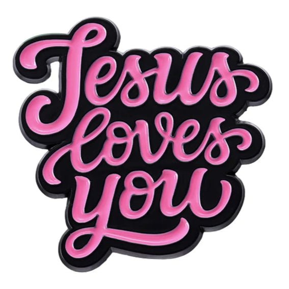 Stylized pink cursive text on black reads Jesus loves you on a pink enamel Jesus Loves You pin.