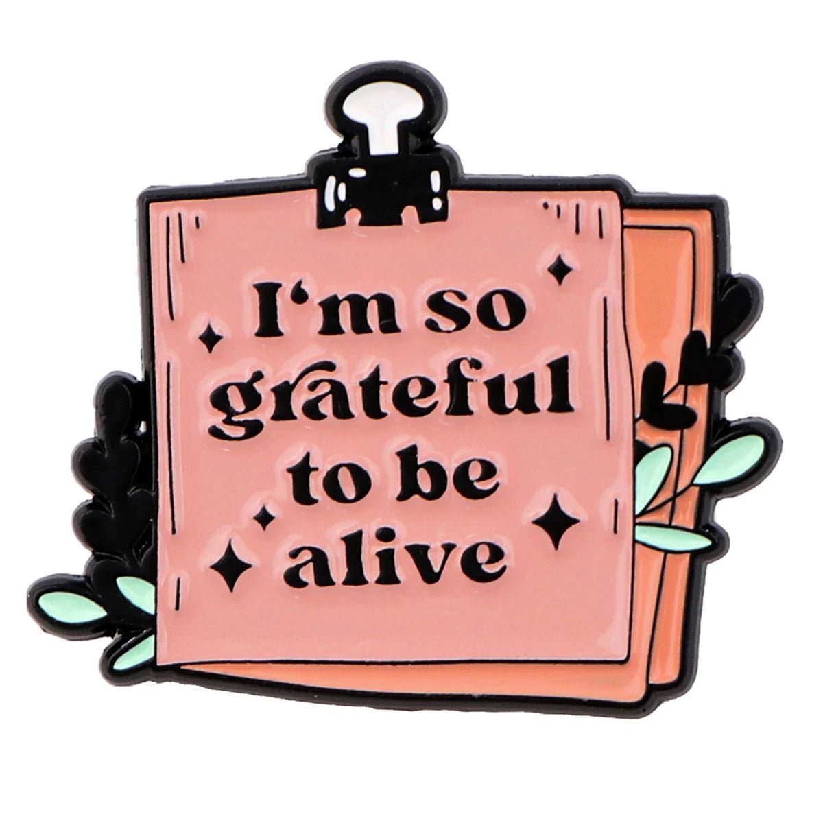 A pink Im so grateful to be alive note badge  clipped at the top with leaves and paper in the background—ideal for promoting positive affirmations and supporting mental health.