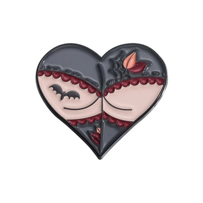 Heart-shaped pin with a gothic design—closed eyes, bat, spiderweb, and autumn leaves—in gray, cream, red, and black.