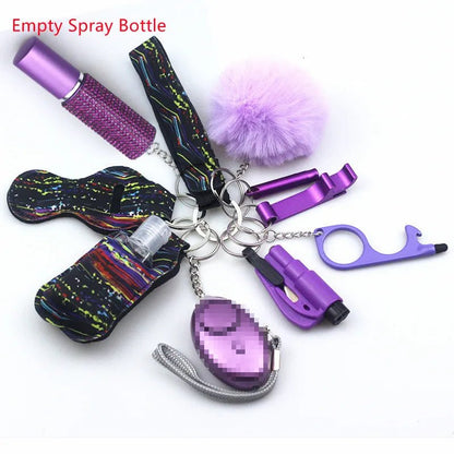 The Kiss Me Later keychain set features purple and multicolored personal safety accessories—a spray bottle, pom-pom, no-touch tool, alarm, lipstick case, and bottle holder—ideal for outdoor adventures.
