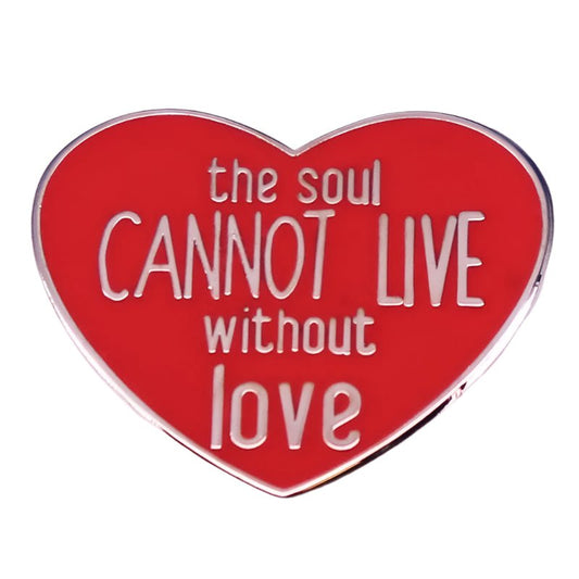 The My Cutesy Era enamel pin features a red love heart with white text that says, the soul CANNOT LIVE without love.