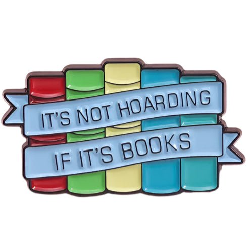 A My Cutesy Era pin featuring red, green, yellow, and blue stacked books, with a blue ribbon that says “IT’S NOT HOARDING IF IT’S BOOKS”—a perfect find for book pin collectors.