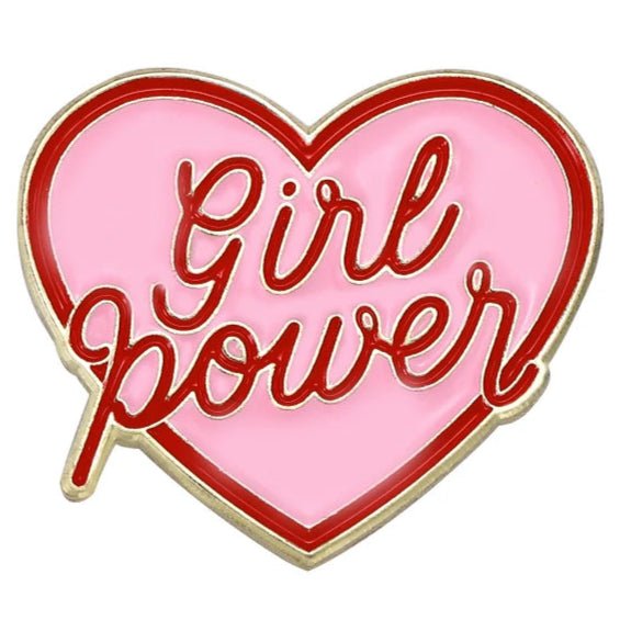  love heart-shaped enamel pin features a pink background, red border, and bold red Girl power script, celebrating self-love and empowerment.