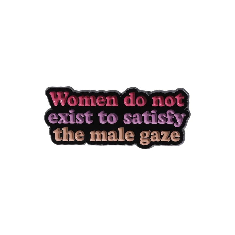 Enamel pin declares Women do not exist to satisfy the male gaze in gradient pink, purple, and beige on black—a bold and empowering statement piece for your feminist collection.