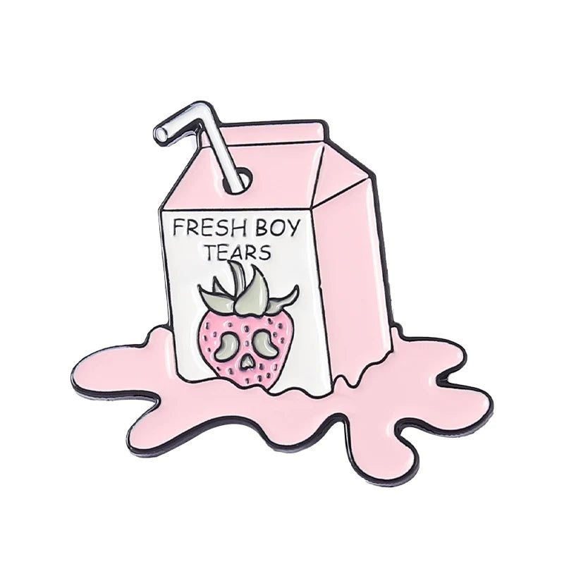 A cartoon-style pink juice box labeled Fresh Boy Tears, featuring a sad strawberry, a straw on top, sitting in a pink puddle, and accented with a playful pink cat pin for extra charm.