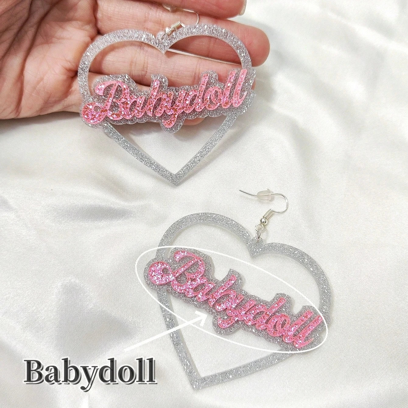 Heart-shaped earrings with 'Babydoll' text