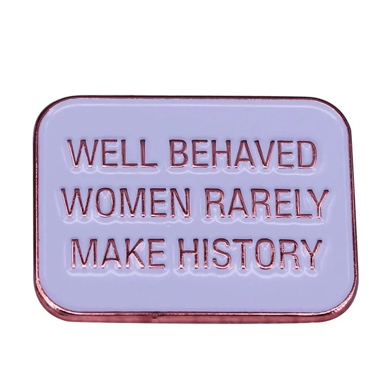 Rectangular feminist pin features a lavender background, rose gold trim, and the engraving WELL BEHAVED WOMEN RARELY MAKE HISTORY—a bold enamel accessory for challenging the status quo.
