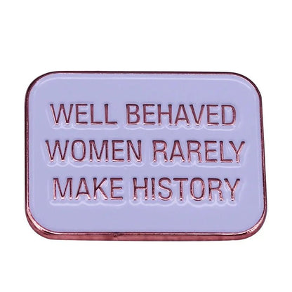 Rectangular feminist pin features a lavender background, rose gold trim, and the engraving WELL BEHAVED WOMEN RARELY MAKE HISTORY—a bold enamel accessory for challenging the status quo.