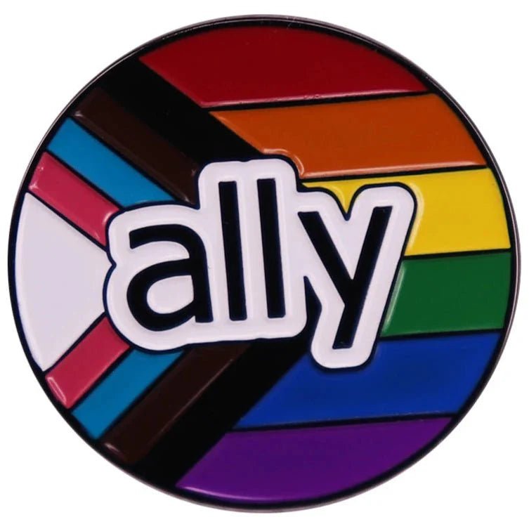 Circular pride ally enamel pin features bold white letters on a vibrant progress pride flag, symbolizing LGBTQ+ inclusivity and support. Worldwide shipping available.