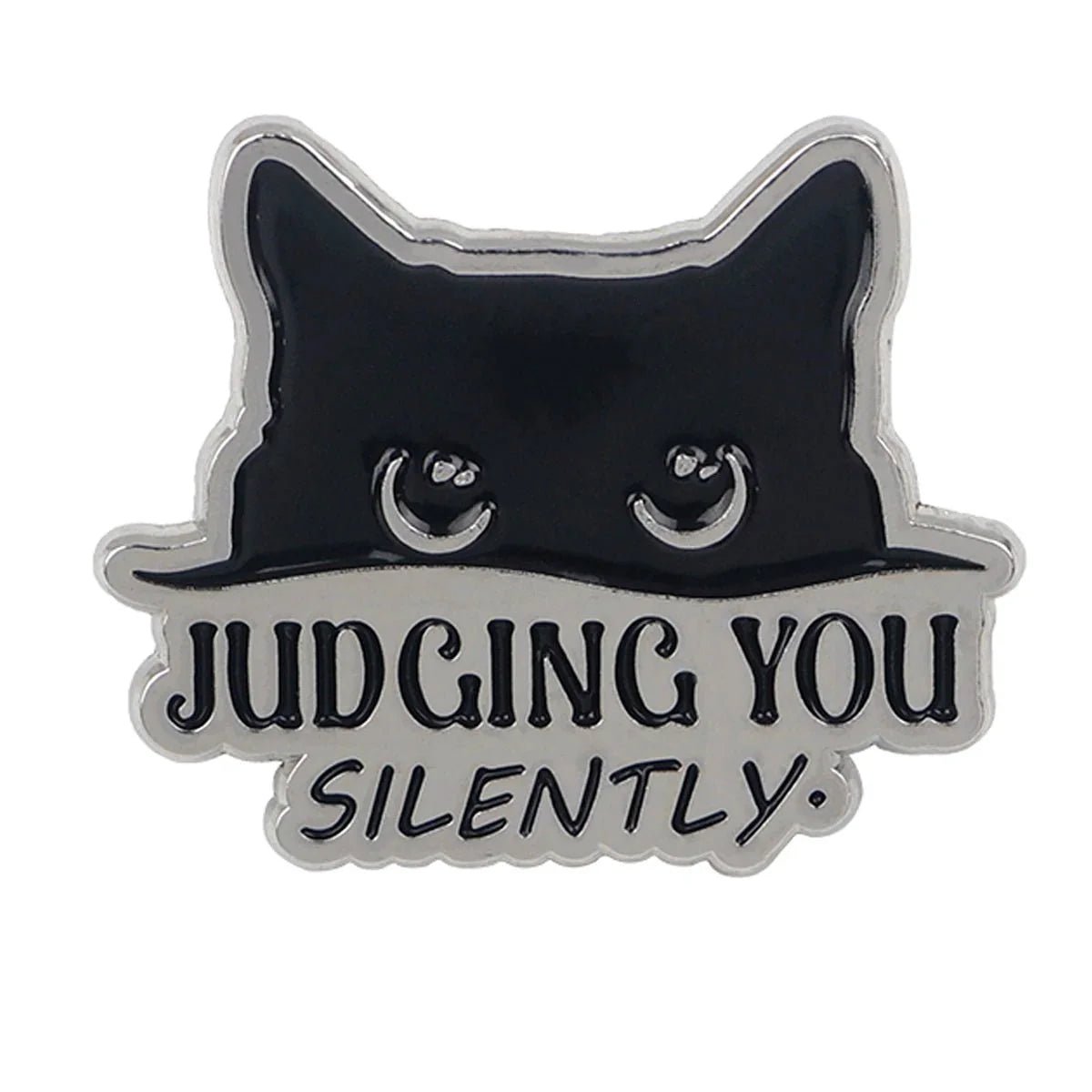 Cat enamel pin features a black cat’s head with wide eyes over bold JUDGING YOU and smaller SILENTLY text. Ideal for cat lovers—worldwide shipping available!.