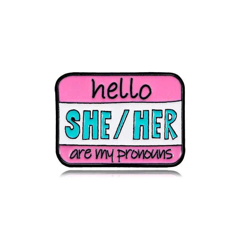 Show off your pronouns with the name tag pin, featuring a pink and white background and hello SHE/HER are my pronouns in black and teal text. Ships worldwide!.
