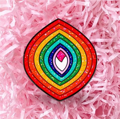 Add sparkle to your style with the Glitter Rainbow Vulva enamel pin—layered, rainbow-colored shapes with glitter detail. Perfect for self-expression and shipped worldwide!.