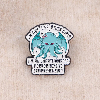 Show off your quirky style with this Gay Skate enamel badge featuring a teal cartoon octopus with bat wings and a pink bow. Text reads, I’m not like other girls—I’m an unfathomable horror beyond comprehension.