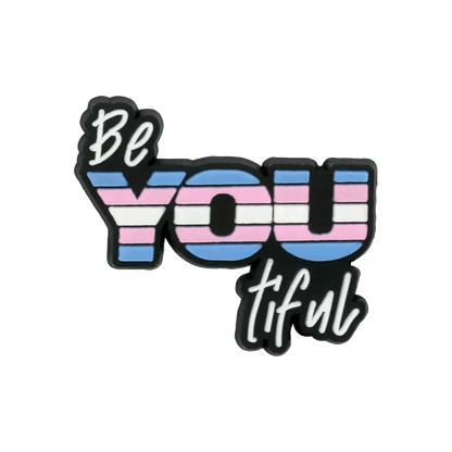 Kiss Me Later’s Be YOU tiful text graphic features YOU in bold Trans Flag colors (blue, pink, white) and the rest in script font—perfect for Pride charms or displays.