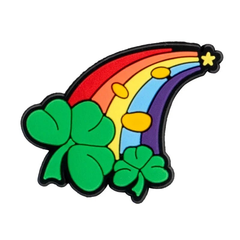A cartoon-style Rainbow Flag with yellow dots and a star arches over two green shamrocks on a white background, evoking pride charm vibes. Brand: Kiss Me Later.