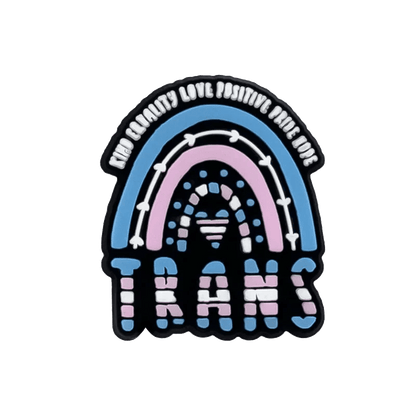 A playful, bold design by Kiss Me Later: a rainbow in blue, pink, and white Trans Flag colors with “Find beauty, love, positivity, pride” above and “TRANS” below—perfect for celebrating with pride charms.
