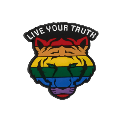A stylized tiger head with rainbow stripes and green eyes, symbolizing LGBTQ+ pride, features pride charms and LIVE YOUR TRUTH above it in bold white letters. From the brand Kiss Me Later.