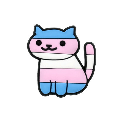 Kiss Me Later’s cartoon cat features bold outlines and Trans Flag colors—blue, pink, and white stripes. The smiling cat sits with its tail curled upward, accented by playful pride charms for a whimsical, affirming look.
