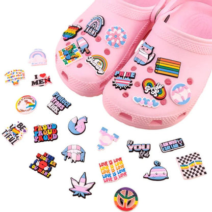 Kiss Me Later pink clogs feature colorful pride charms like Rainbow and Trans Flags, supportive messages, and inclusive themes. Extra matching charms are also included, celebrating positivity and diversity.