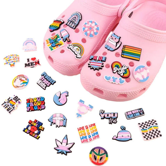 Kiss Me Later pink clogs feature colorful pride charms like Rainbow and Trans Flags, supportive messages, and inclusive themes. Extra matching charms are also included, celebrating positivity and diversity.