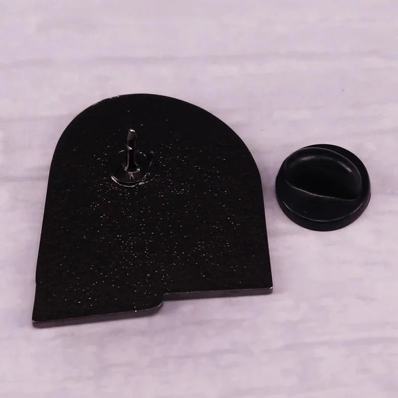 A black, arched enamel badge face down beside its round black rubber backing on a light background. Libraries Are For Everyone. Ships worldwide.