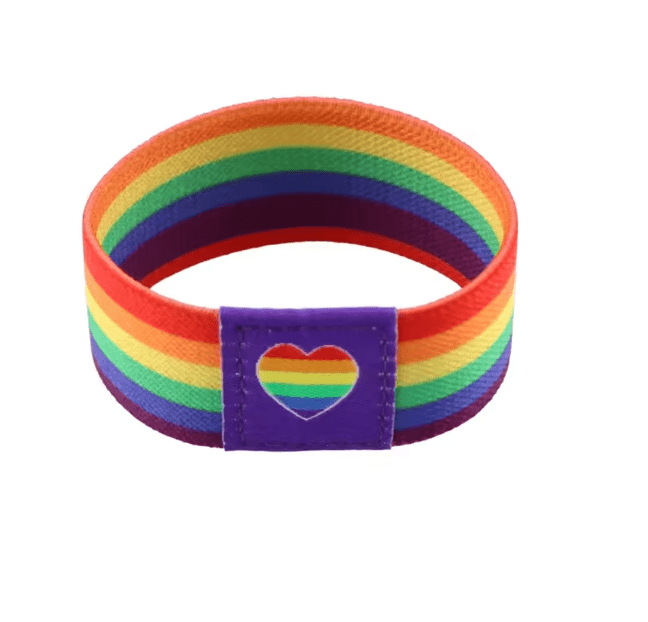 A vibrant Gay Skate fabric wristband with rainbow stripes and a purple patch featuring a heart-shaped rainbow cutout, perfect for celebrating LGBTQ+ pride and the spirit of the rainbow flag.