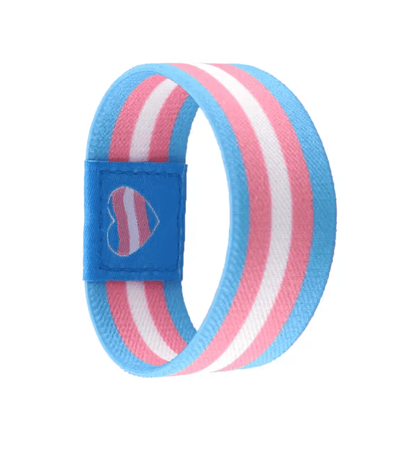 A Gay Skate fabric wristband with blue, pink, and white stripes resembling the Trans pride flag, plus a blue patch with a matching heart—an ideal Pride accessory to show your support.