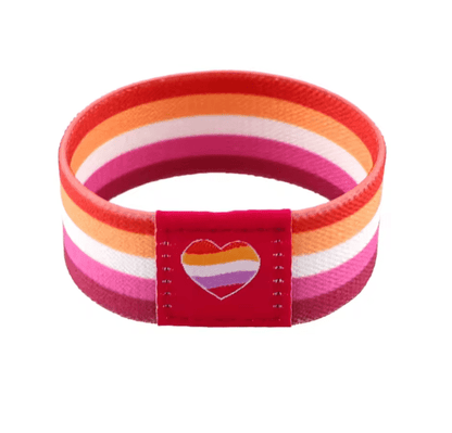 The Gay Skate fabric wristband has horizontal stripes in orange, pink, red, and white with a cute heart patch—ideal as a colorful pride accessory.