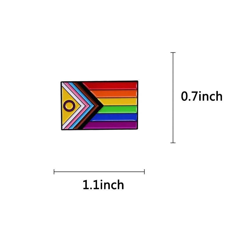 The Gay Skate small Pride pin (1.1 x 0.7) features the Progress Pride flag’s rainbow stripes, chevron in black, brown, pink, blue, and white, plus a yellow triangle with a purple circle for inclusive representation.