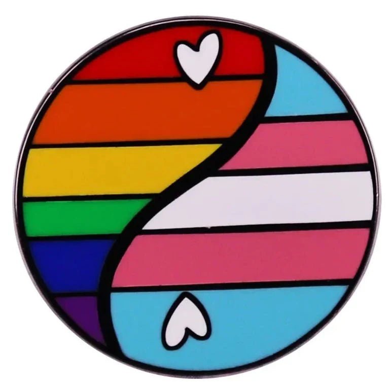 a circular heart-shaped accessory with a yin-yang design: one side shows rainbow stripes with a white heart, the other features bisexual pride flag colors and another white heart.
