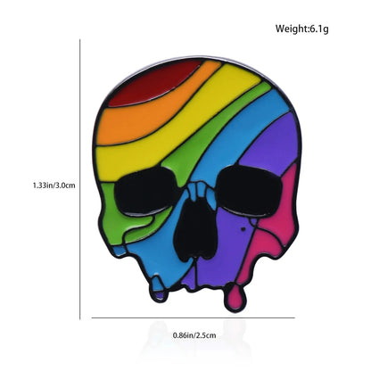 Rainbow Pride Skull enamel pin features rainbow stripes, black details, and a drop-shaped charm. Size: 1.33 x 0.86 inches, weight: 6.1g. Ships worldwide.