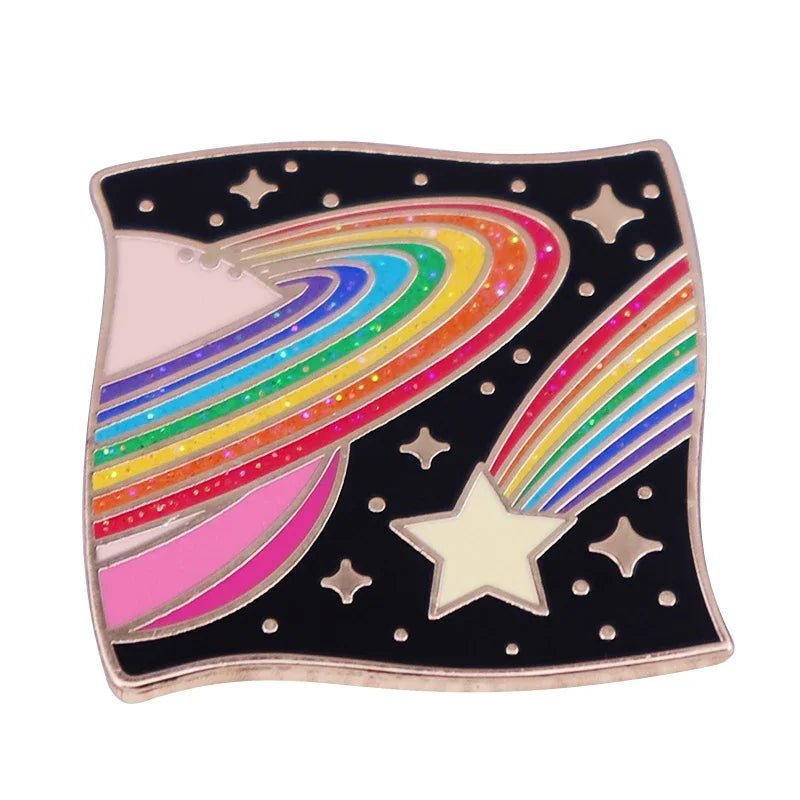 The Kiss Me Later square enamel pin features a colorful rainbow-striped planet, a matching comet, and yellow stars on a black background—a vibrant galaxy accessory for space lovers.