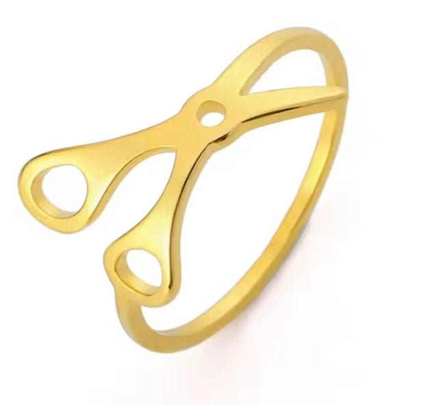 Discover the Scissor Ring, crafted in gold with handle and blade motifs—a standout accessory for creative sapphic pride.