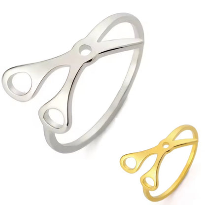 Scissor Rings, crafted from stainless steel in silver and gold, feature an open scissor design and are shown on a white background—perfect as stylish sapphic pride accessories.
