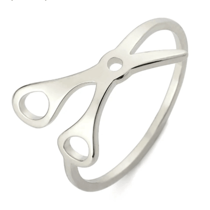Scissor Ring is crafted from stainless steel and showcases open scissor handles and blades—an eye-catching, unique sapphic pride accessory.