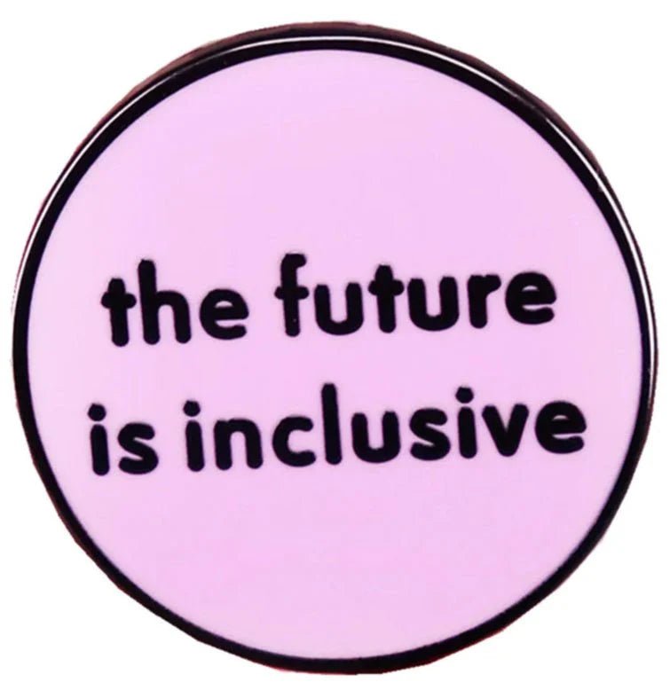 Lght pink circular enamel pin features bold black text, “the future is inclusive”—a perfect addition to pride items and inclusive accessories collections.