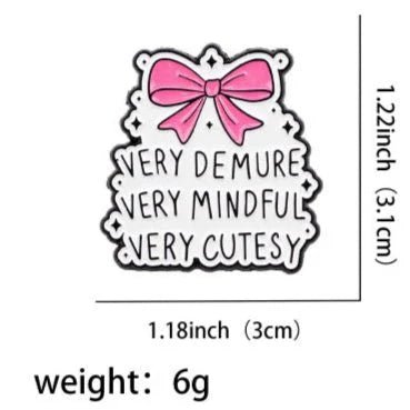 A black and white enamel pin with a pink bow on top and VERY DEMURE VERY MINDFUL VERY CUTESY text below. Measures 1.22 x 1.18, weighs 6g—a charming addition to your collection!.
