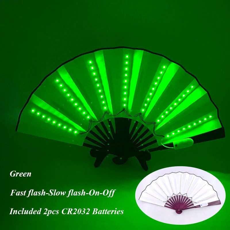 A My Cutesy Era handheld folding fan with green LEDs shines brightly in the dark. An inset displays the unlit fan. Text highlights multiple flash modes and included batteries.