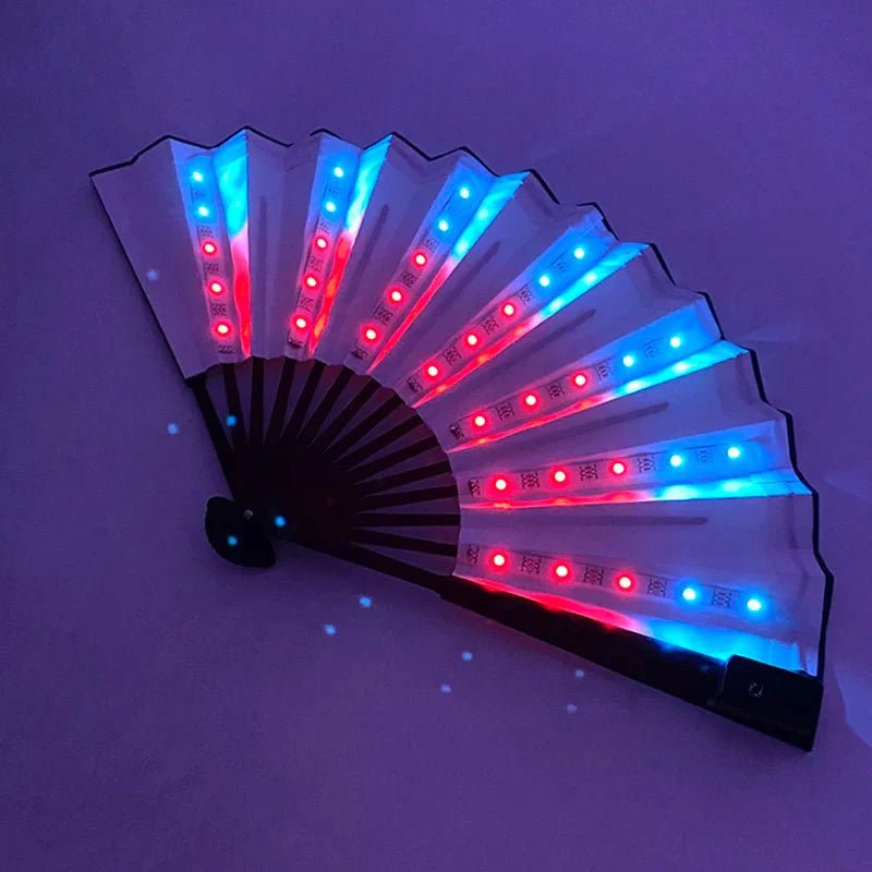 The My Cutesy Era handheld folding fan features transparent panels lit by blue and red LEDs, glowing against a purple background—ideal for parties and events.