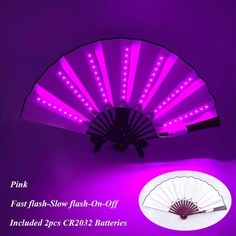 The My Cutesy Era pink folding fan features glowing LED lights, multiple flash modes, and comes with included batteries. An inset shows the battery-powered fan when unlit.