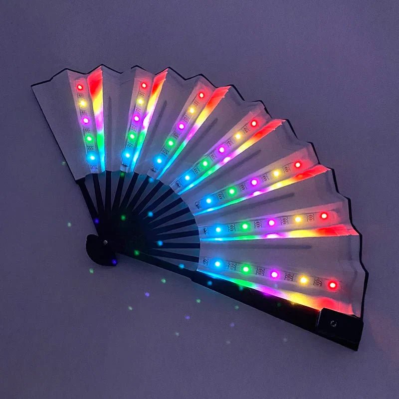 The My Cutesy Era battery-powered LED folding fan features transparent panels that glow with vibrant rainbow colors, creating a stunning visual effect in the dark. This handheld fan lights up brilliantly for an eye-catching look.