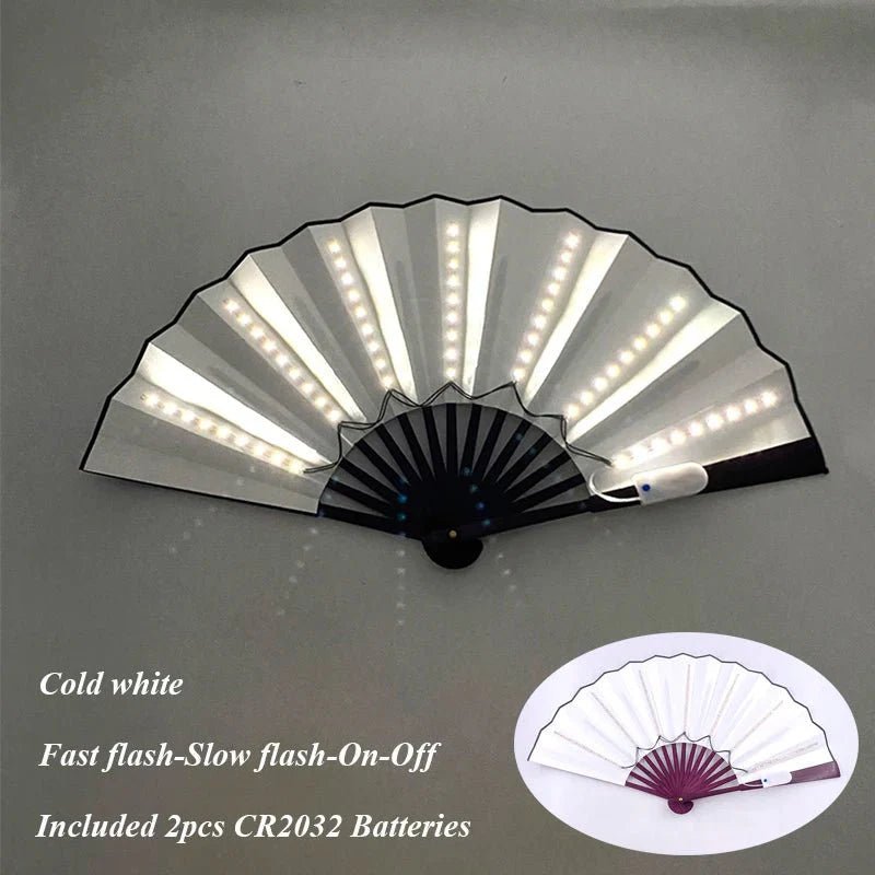 A handheld, battery-powered LED fan by My Cutesy Era features built-in white LEDs on each rib. Displayed open, text reads: Cold white. Fast flash-Slow flash-On-Off. Includes 2 CR2032 batteries. Inset highlights fan’s design.
