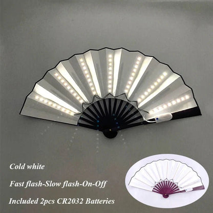 A handheld, battery-powered LED fan by My Cutesy Era features built-in white LEDs on each rib. Displayed open, text reads: Cold white. Fast flash-Slow flash-On-Off. Includes 2 CR2032 batteries. Inset highlights fan’s design.