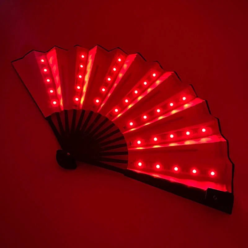 The My Cutesy Era rechargeable LED fan glows with bright red lights, evenly spaced along each open panel, against a dark red background.